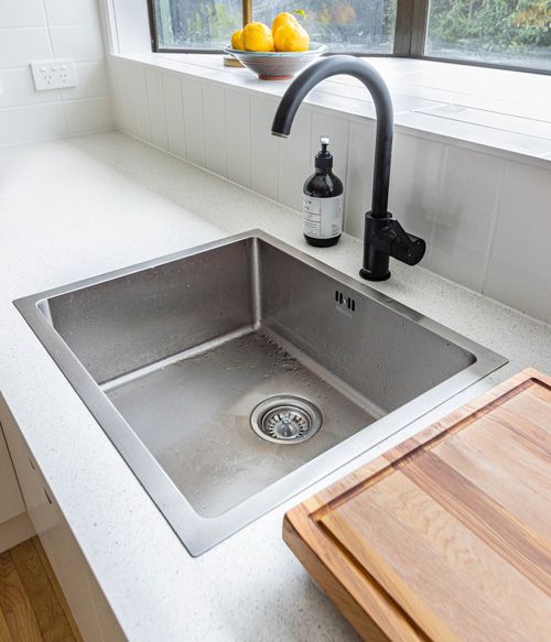 stainless steel utility sink in modern mudroom