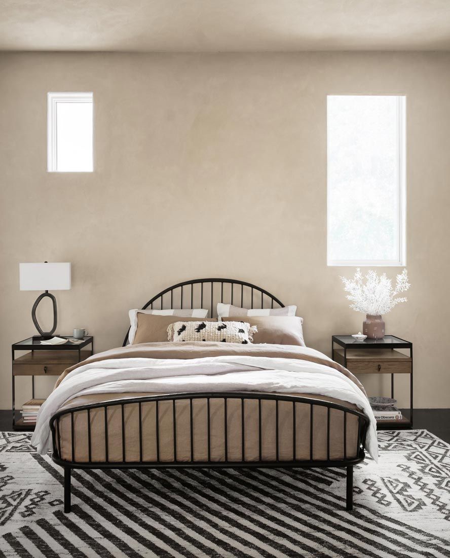mediterranean style bedroom with antique metal bed frame