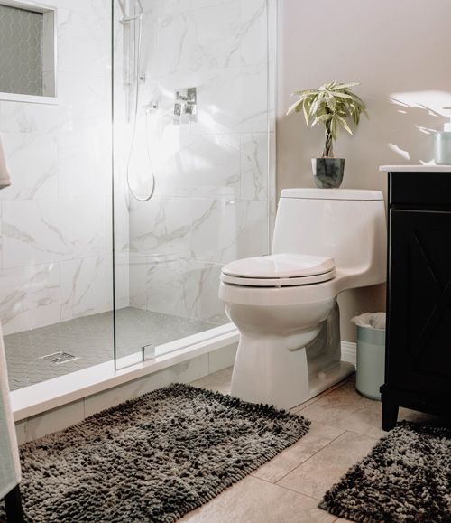 toilet in a brown and white bathroom