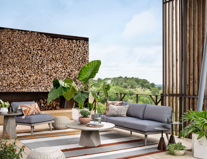 accessorized outdoor living space with neutral furniture colors and accessories