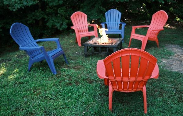 PVC plastic outdoor chairs arranged around a fire