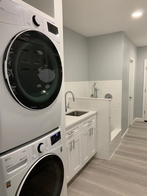 laundry room with stacked appliances