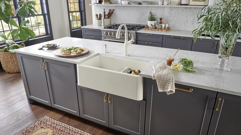 modern farmhouse kitchen featuring a light gray color scheme and farmhouse sink