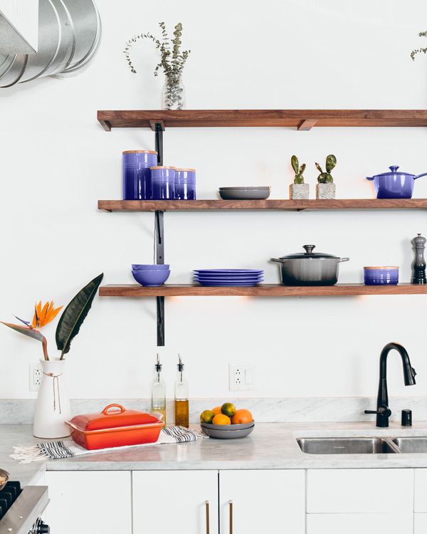 purple 2022 color of the year pottery accents on an open shelf in the kitchen