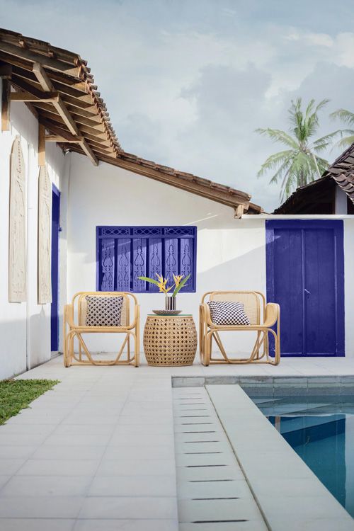 outdoor patio area with a purple door and purple shutters
