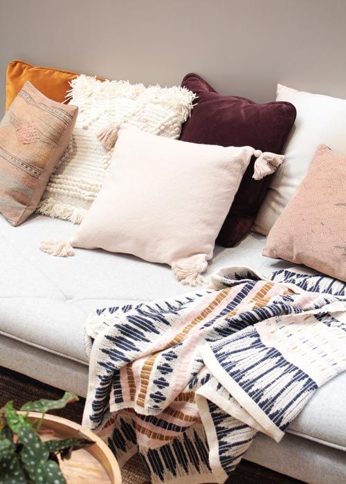 throw pillows and blanket in cottage style home