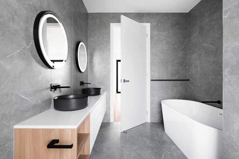 grey bathroom with white freestanding bathtub