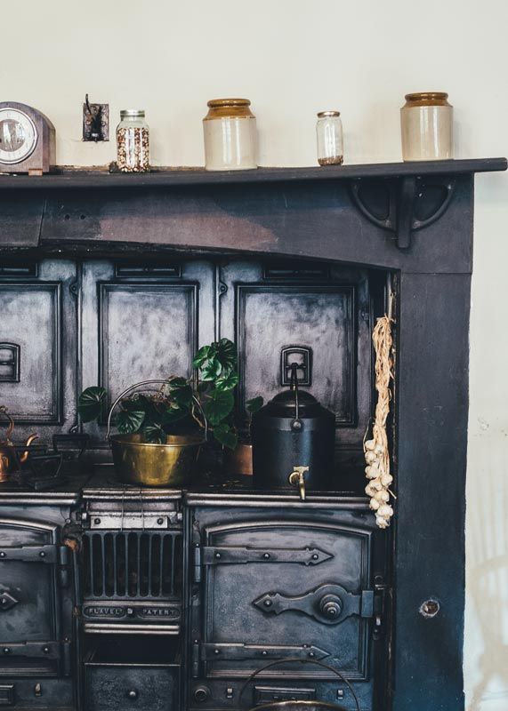 antique pots and stove in cottage home