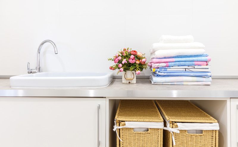 laundry room sink with flowers and clothing